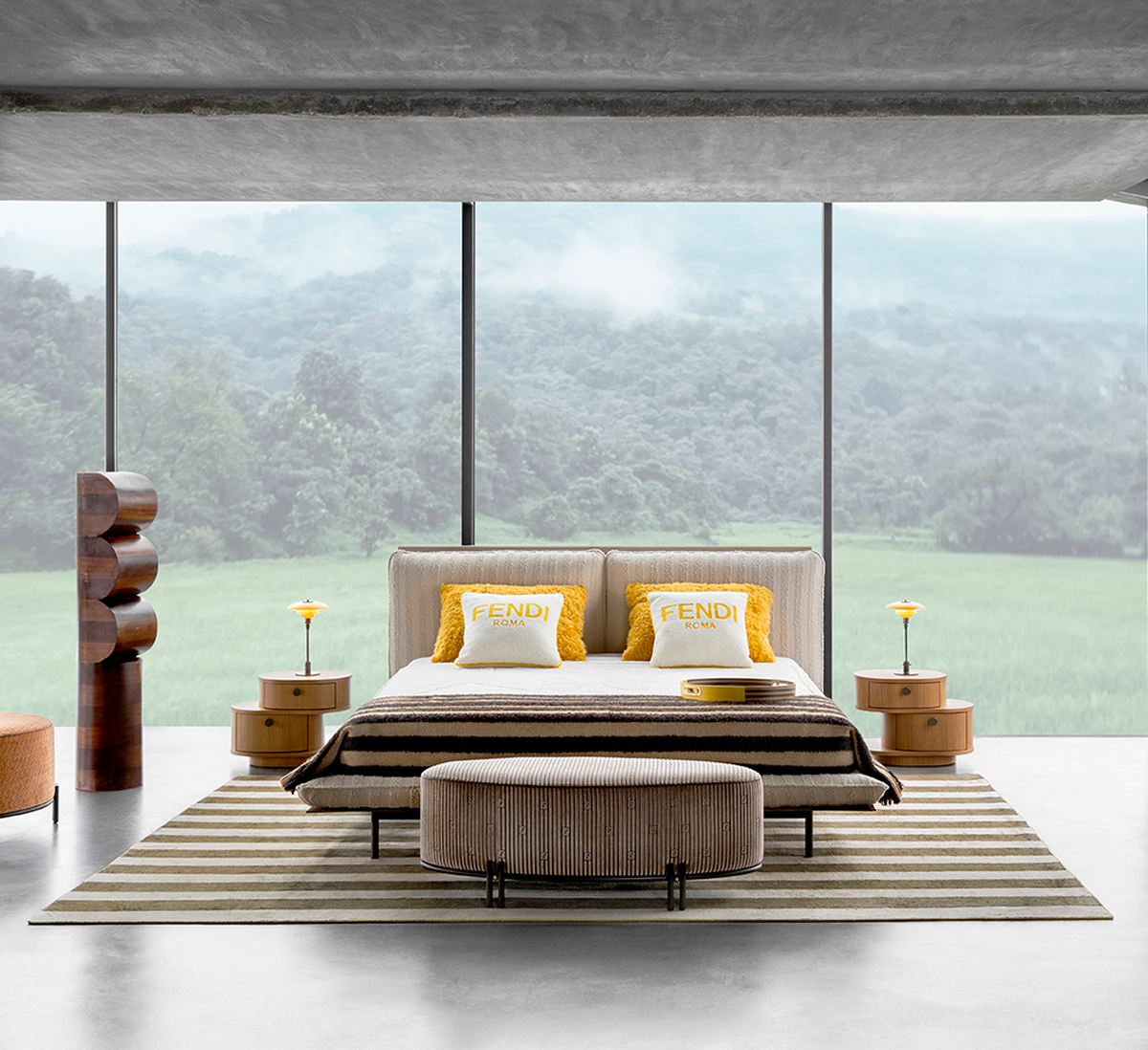 Luxury bedroom with Fendi Casa bed, striped rug, and floor-to-ceiling windows overlooking lush green landscape.