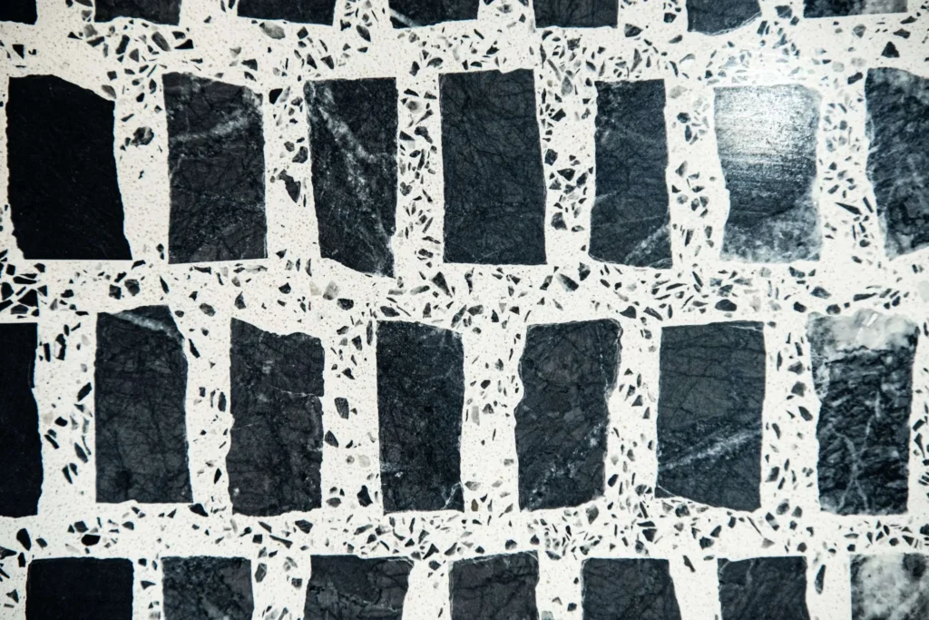 Close-up of Carlo Scarpa’s signature geometric stone flooring with contrasting black and white terrazzo inlays.