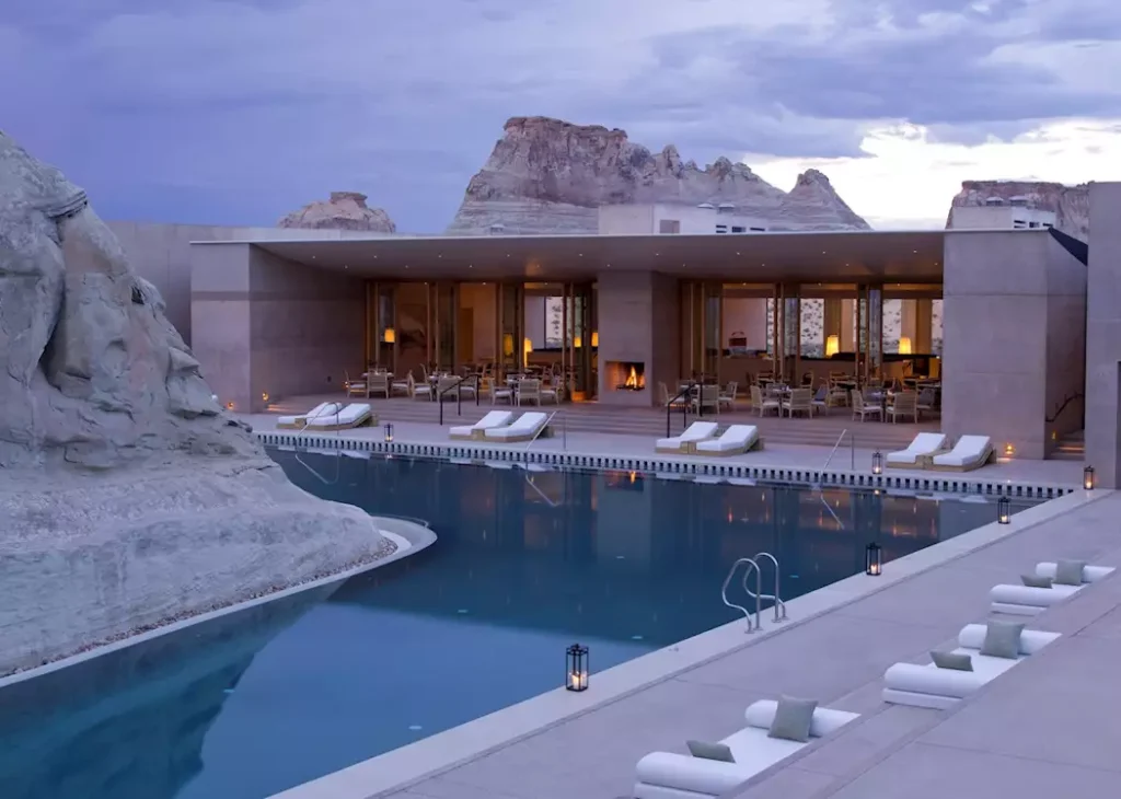 Luxury Amangiri resort in Utah with minimalist architecture, infinity pool, and desert canyon landscape in the background.