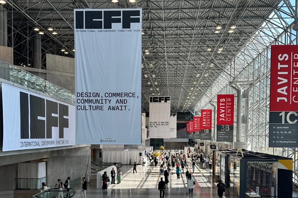 International Contemporary Furniture Fair (ICFF) at Javits Center New York with banners, exhibitors, and visitors.