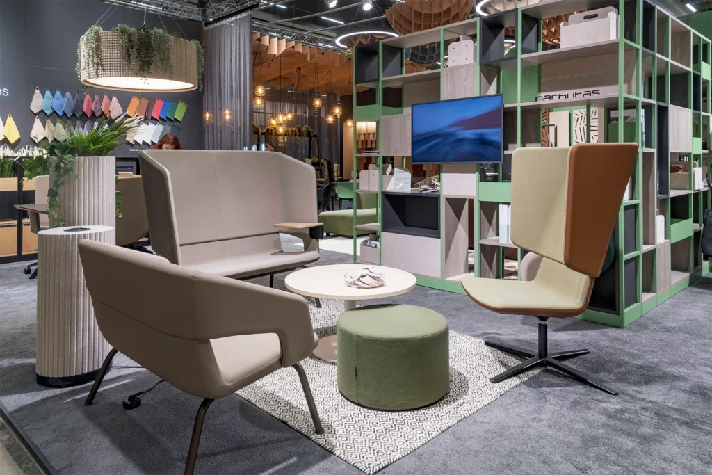 Modern furniture display at Stockholm Furniture & Light Fair with colorful textiles and innovative seating design.