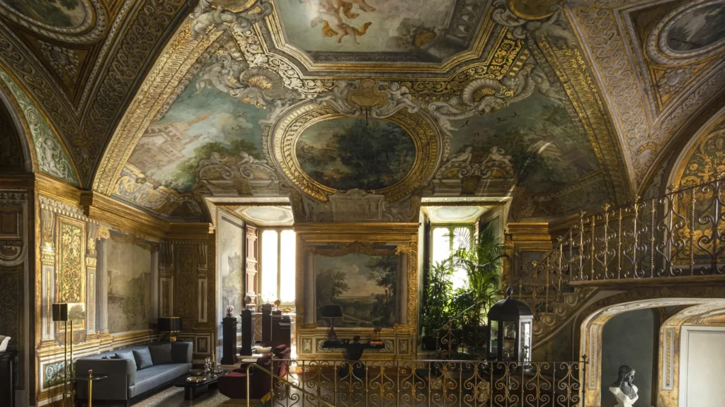 Lavish palazzo interior with gilded frescoed ceilings, baroque murals, and ornate architectural details.