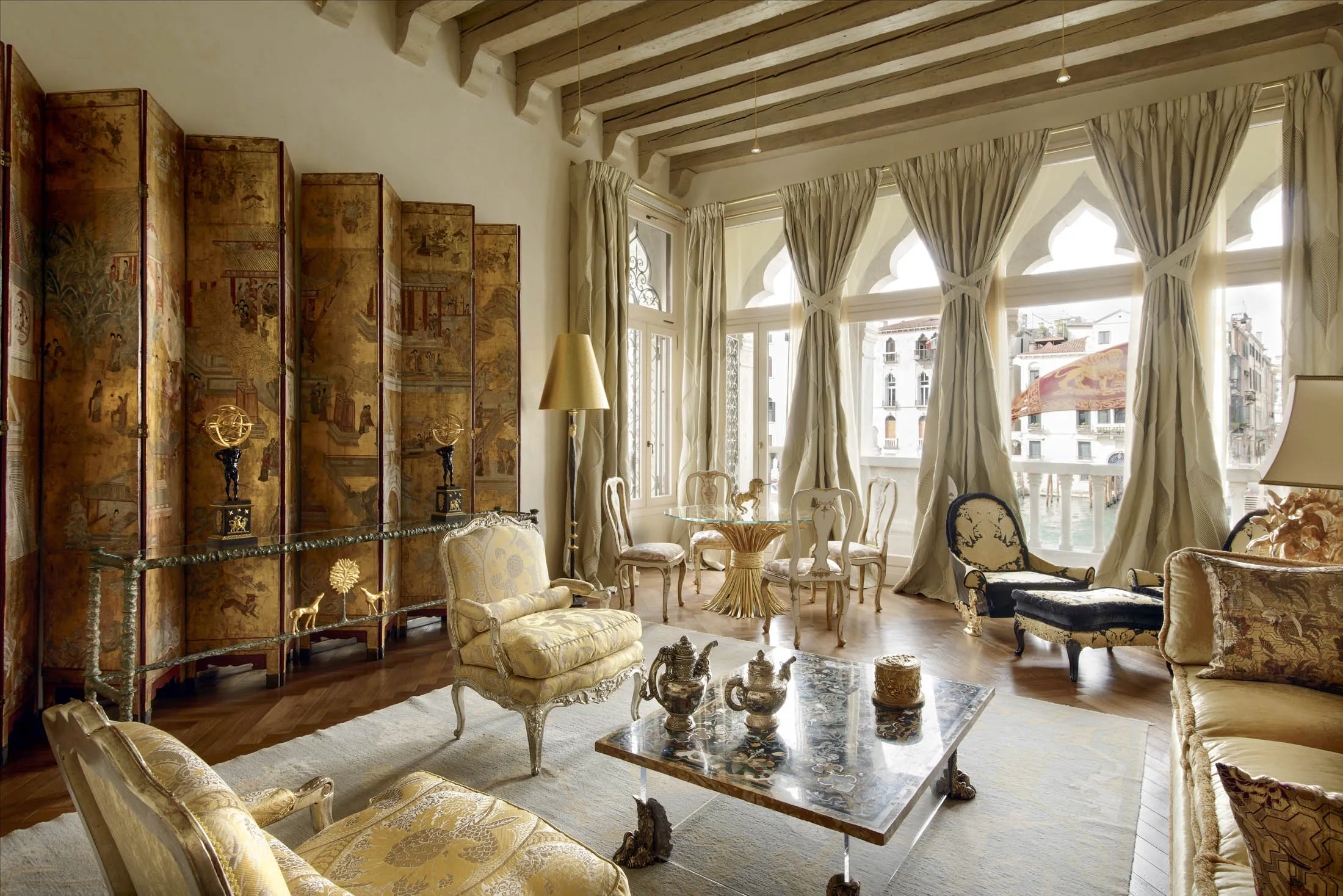 Opulent Venetian palazzo salon with gold accents, brocade furniture, and views of the Grand Canal.