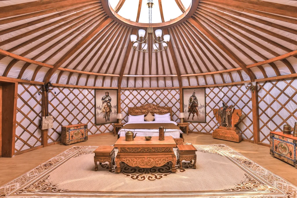 Traditional Mongolian yurt interior with carved wooden furniture and intricate cultural décor