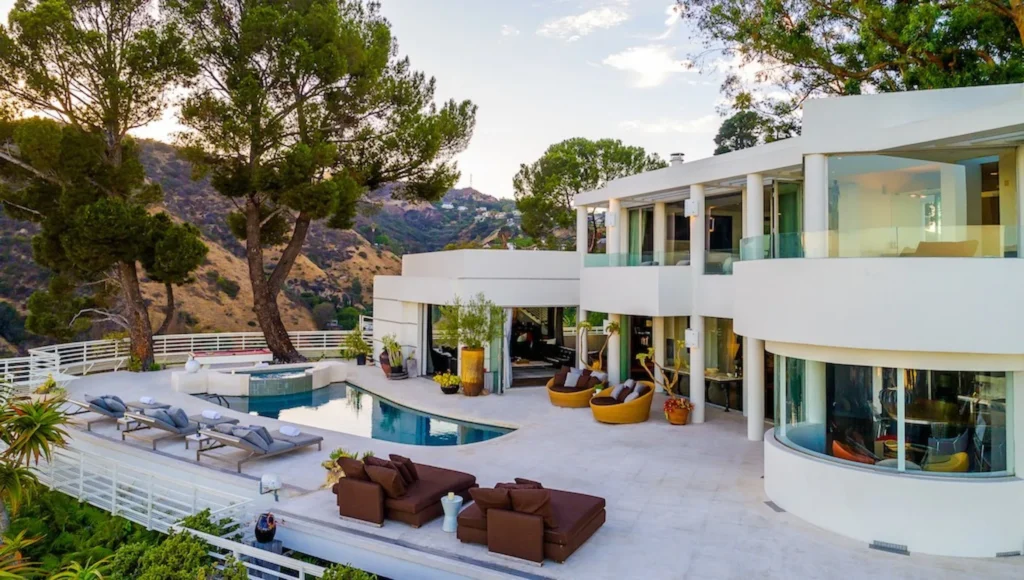 Luxury white villa in the Hollywood Hills with curved architecture, infinity pool, and scenic mountain views.