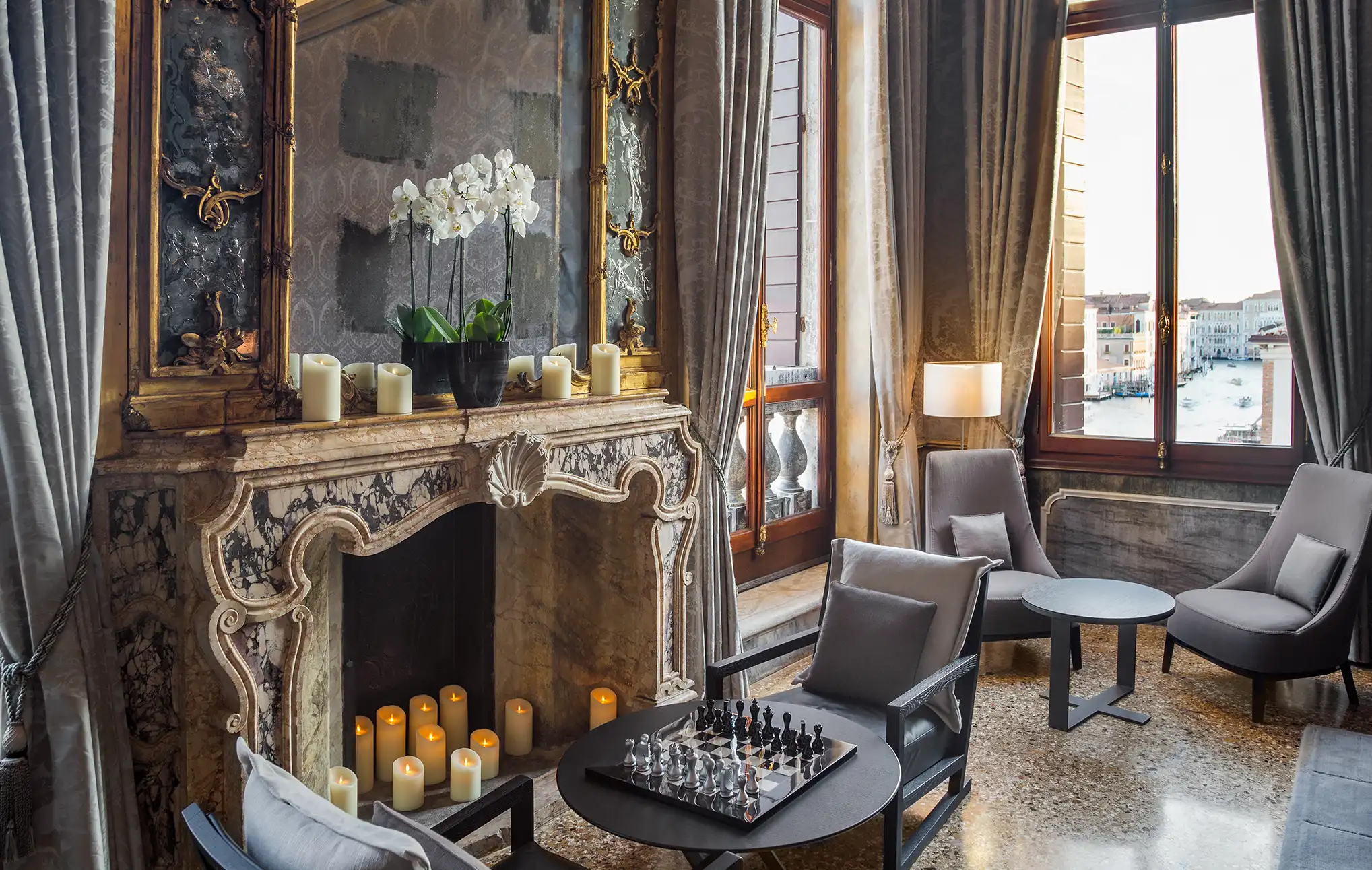Room with a fireplace, table chairs and a chessboard