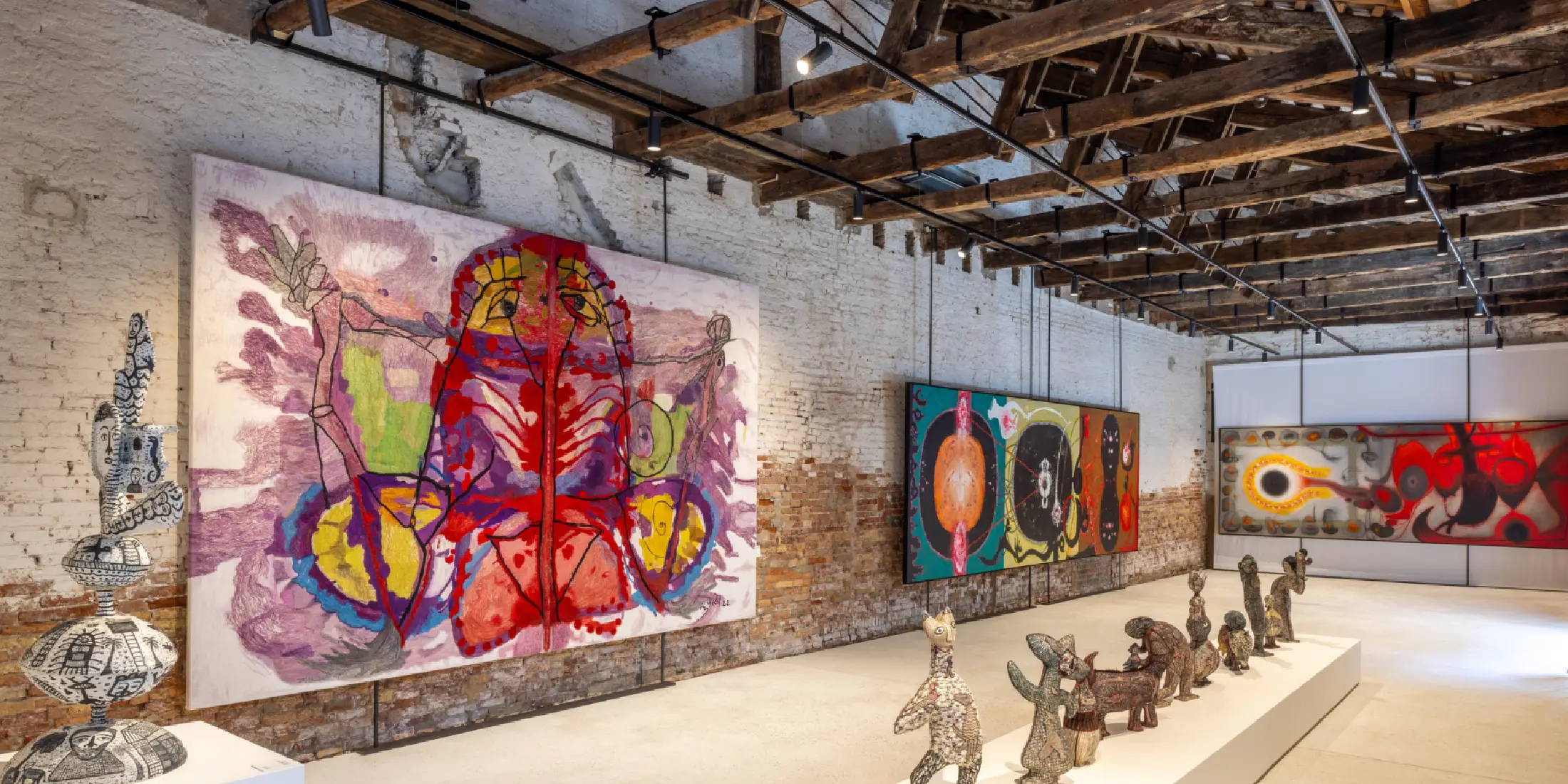 Global art collectors viewing certified authentic pieces created through Handmade Traditions.