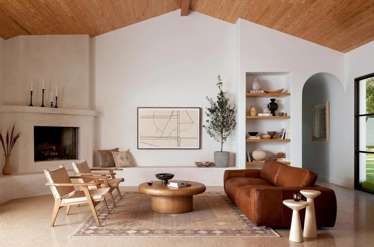Contemporary Mediterranean interior design featuring artisan craftsmanship, natural stone walls, warm neutral tones, textured surfaces, and modern minimalist architectural styling.