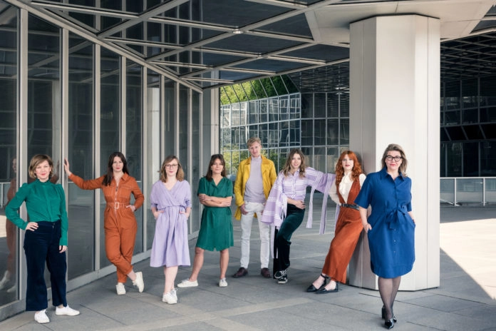 Vienna Design Week team posing together outside a contemporary architectural setting in Vienna.