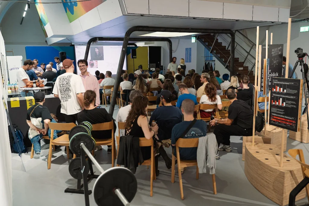 Guests gather outdoors at night during the Vienna Motion Bunch 001 event at Vienna Design Week 2024.